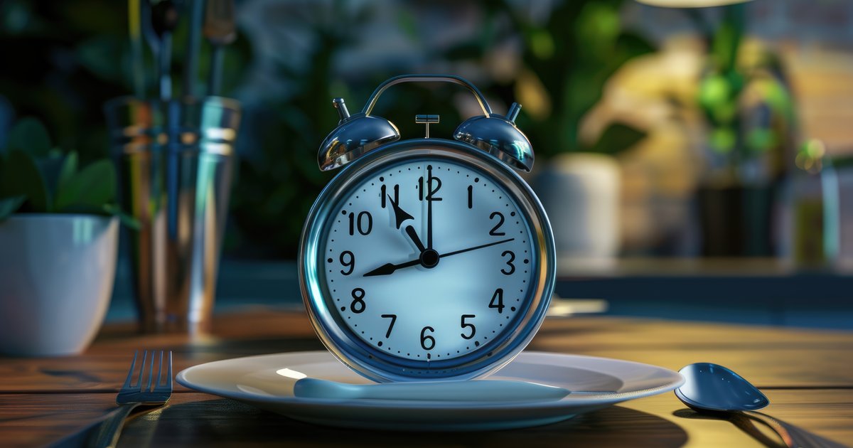 Illustrative image of a clock on a plate with a fork and knife